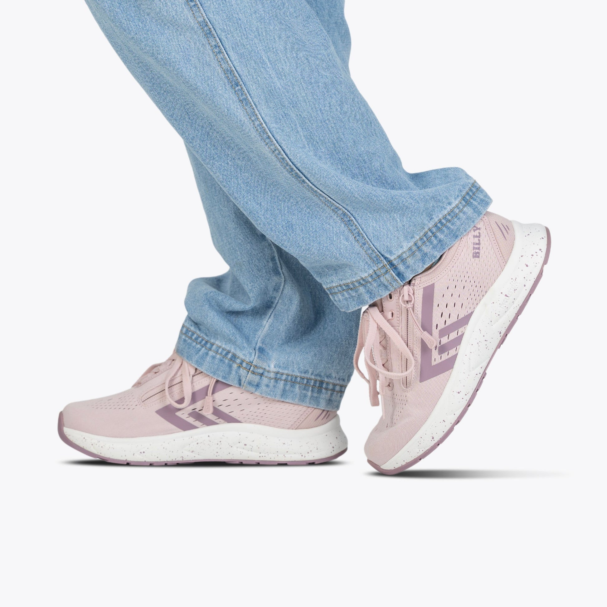 A person in light blue jeans wears BILLY Footwear Women's Mauve/White/Plum BILLY Sport Inclusion DZ1 sneakers, standing on a white background.